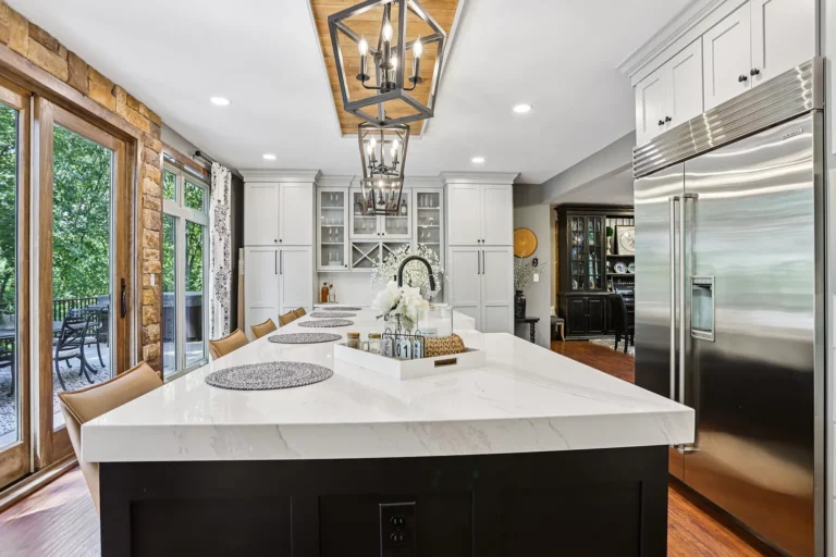 Remodeled kitchen with white cabinetry and a large island